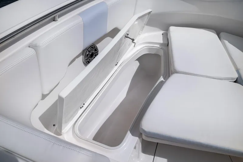 Slide: The Image of 2023 Robalo R302 Center Console boat with open storage compartment and cushioned seating. - 35