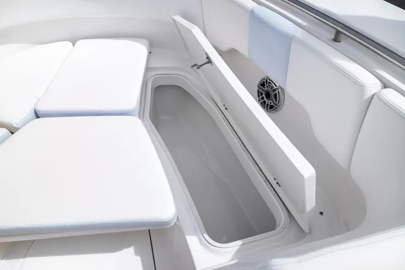 Slide: The Image of 2023 Robalo R302 Center Console boat interior with open storage compartment and cushioned seating. - 37