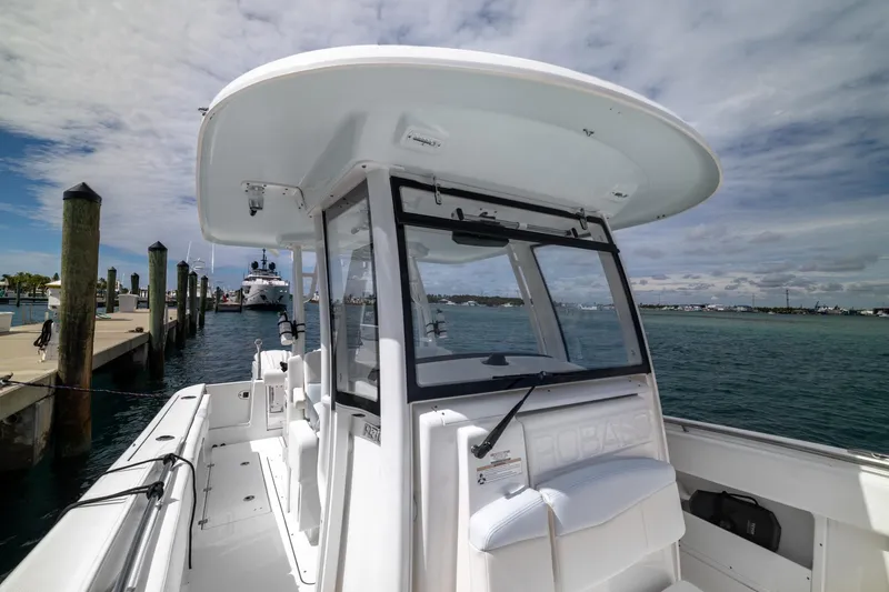 Slide: The Image of 2023 Robalo R302 Center Console boat docked at marina under cloudy sky. - 38