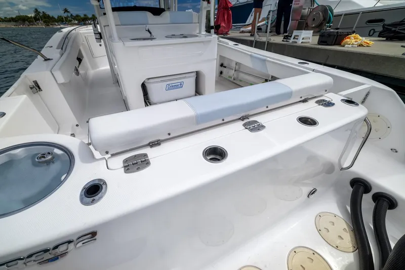 Slide: The Image of 2023 Robalo R302 Center Console boat interior with seating and storage features. - 39