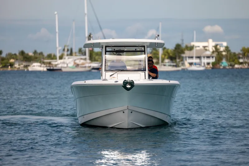 Slide: The Image of 2023 Robalo R302 Center Console boat cruising on calm waters. - 4