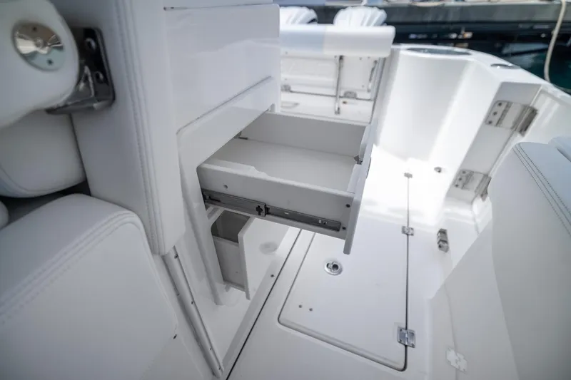 Slide: The Image of 2023 Robalo R302 Center Console boat interior with open storage drawer. - 40