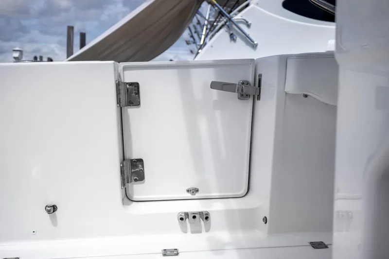 Slide: The Image of 2023 Robalo R302 Center Console boat hatch with stainless steel hinges and latch. - 41