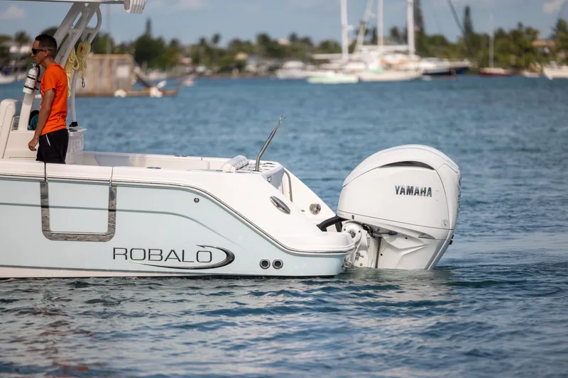 Slide: The Image of 2023 Robalo R302 Center Console boat with Yamaha engine on water. - 5