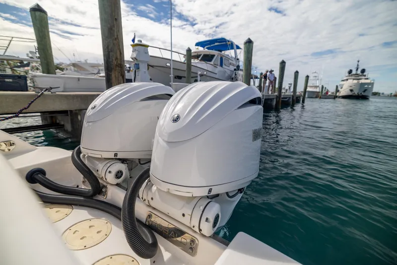 Slide: The Image of 2023 Robalo R302 Center Console with dual outboard engines at marina. - 8