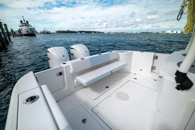 Slide: The Image of 2023 Robalo R302 Center Console boat with dual engines on calm water. - 9