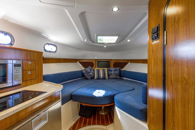 Slide: The Image of 2012 Pursuit 345 Offshore Convertible V-berth-Electrically Actuated Tabletop lowers to form base for filler cushion - 22