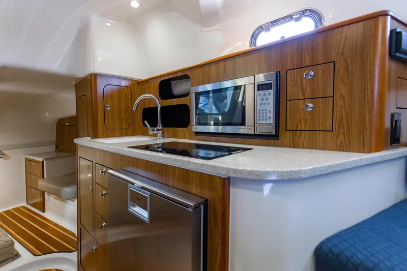 Slide: The Image of 2012 Pursuit 345 Offshore Galley and entry into Mid Cabin - 25