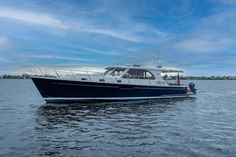 The Image of 2014 Grand Banks 50 Eastbay SX yacht on calm water under blue sky. - 0