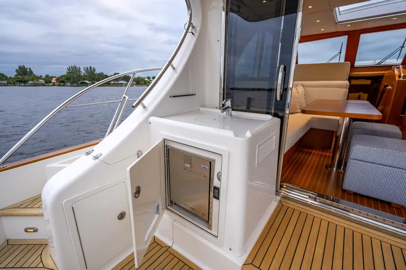 Slide: The Image of 2014 Grand Banks 50 Eastbay SX yacht interior with open door and seating area. - 13