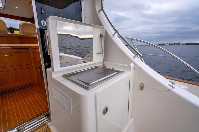 Slide: The Image of 2014 Grand Banks 50 Eastbay SX yacht interior with ocean view and wooden cabinetry. - 15