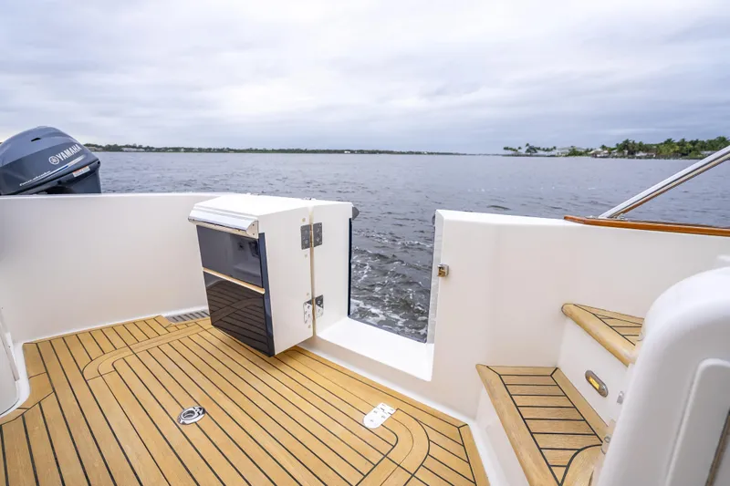 Slide: The Image of 2014 Grand Banks 50 Eastbay SX yacht deck with teak flooring and Yamaha engine. - 16