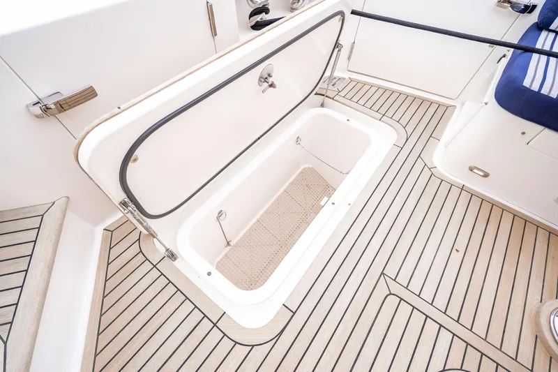 Slide: The Image of 2014 Grand Banks 50 Eastbay SX yacht storage compartment with teak flooring. - 18