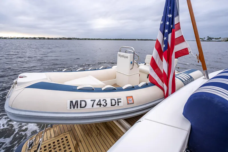 Slide: The Image of Inflatable boat on Grand Banks 50 Eastbay SX, 2014, with American flag on calm water. - 19