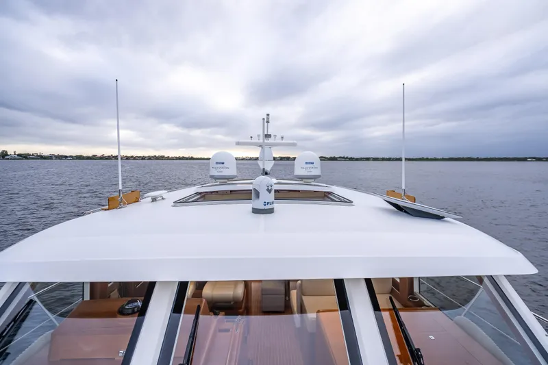Slide: The Image of 2014 Grand Banks 50 Eastbay SX yacht on calm waters under cloudy sky. - 25