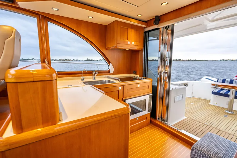 Slide: The Image of Luxurious 2014 Grand Banks 50 Eastbay SX yacht interior with wooden cabinetry and ocean view. - 36