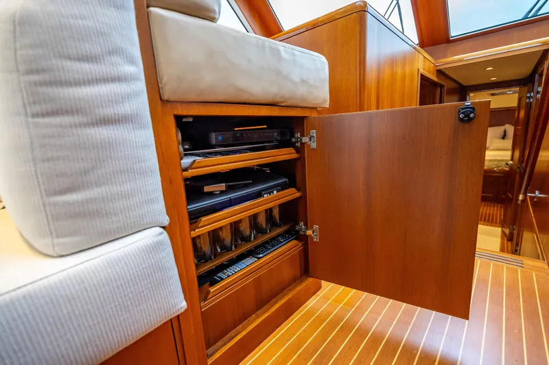 Slide: The Image of Interior of 2014 Grand Banks 50 Eastbay SX yacht with open wooden cabinet. - 43