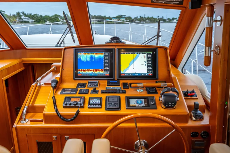 Slide: The Image of Helm of 2014 Grand Banks 50 Eastbay SX with navigation screens and controls. - 47