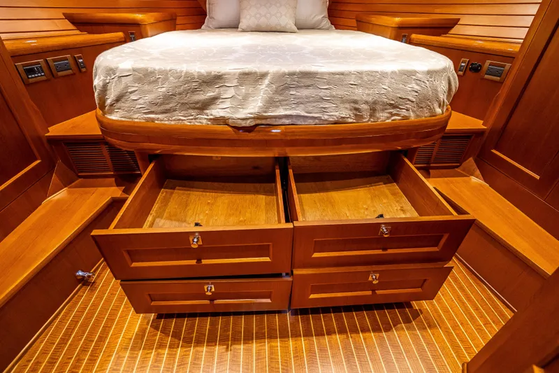 Slide: The Image of Luxurious 2014 Grand Banks 50 Eastbay SX cabin with wooden storage drawers under bed. - 53