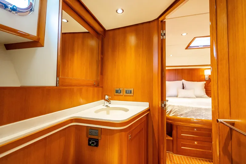 Slide: The Image of Luxurious 2014 Grand Banks 50 Eastbay SX yacht interior with wooden cabinetry and cozy bedroom. - 54
