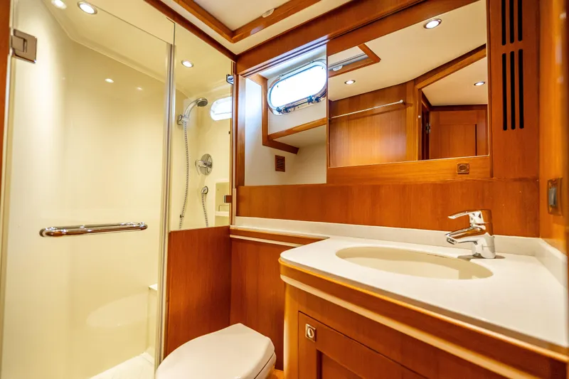 Slide: The Image of Luxurious bathroom in 2014 Grand Banks 50 Eastbay SX yacht with wood accents and modern fixtures. - 55