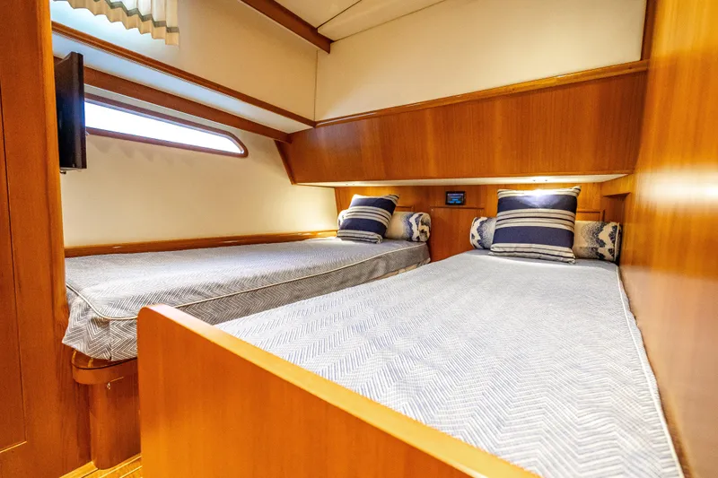 Slide: The Image of 2014 Grand Banks 50 Eastbay SX cabin with twin beds and nautical decor. - 58