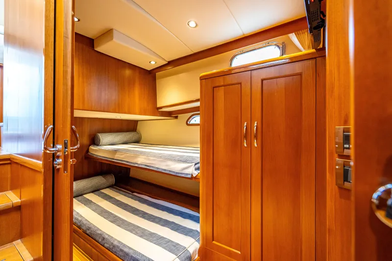 Slide: The Image of Luxurious wooden cabin interior of 2014 Grand Banks 50 Eastbay SX yacht with bunk beds. - 59