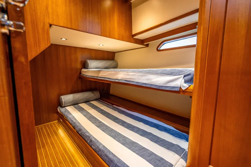 Slide: The Image of 2014 Grand Banks 50 Eastbay SX cabin with wooden interior and bunk beds. - 60