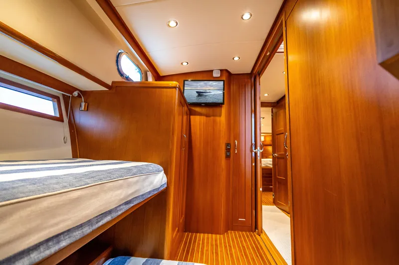 Slide: The Image of Luxurious 2014 Grand Banks 50 Eastbay SX yacht interior with wood paneling and cozy cabin. - 61