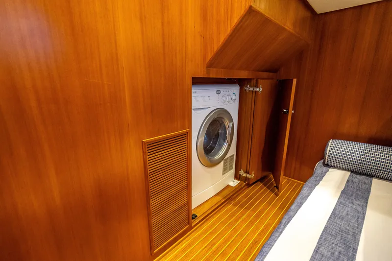 Slide: The Image of Laundry area inside 2014 Grand Banks 50 Eastbay SX yacht with wood paneling. - 62