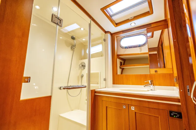 Slide: The Image of Luxurious bathroom in 2014 Grand Banks 50 Eastbay SX yacht with wood accents and modern fixtures. - 63