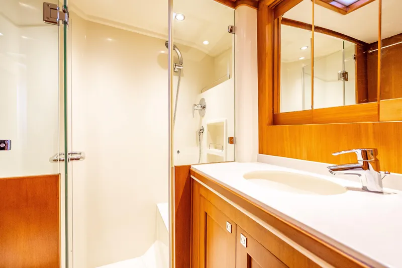 Slide: The Image of Luxurious bathroom in 2014 Grand Banks 50 Eastbay SX yacht with wood accents and modern fixtures. - 64