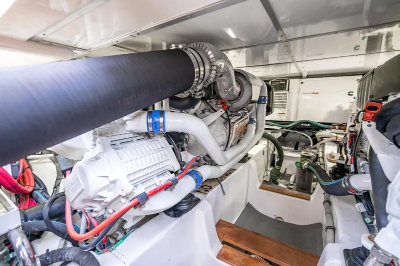 Slide: The Image of Engine room of 2014 Grand Banks 50 Eastbay SX yacht, showcasing mechanical components. - 68