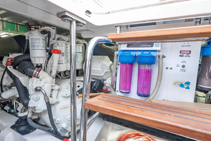 Slide: The Image of Engine room of 2014 Grand Banks 50 Eastbay SX with filtration system and Volvo components. - 70