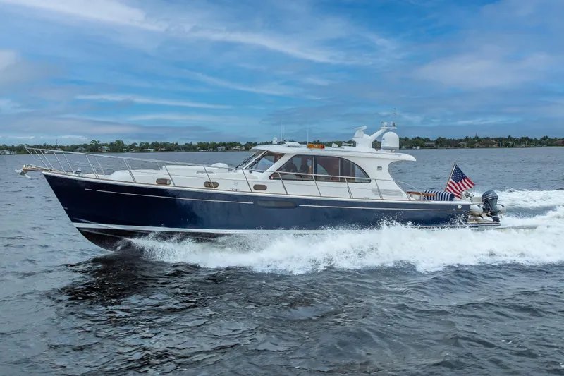 Slide: The Image of 2014 Grand Banks 50 Eastbay SX yacht cruising on open water, American flag displayed. - 74