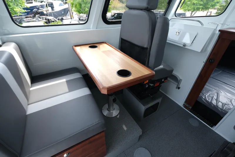 Slide: The Image of Interior of 2025 Hewescraft 240 Pacific Cruiser with seating and table. - 11