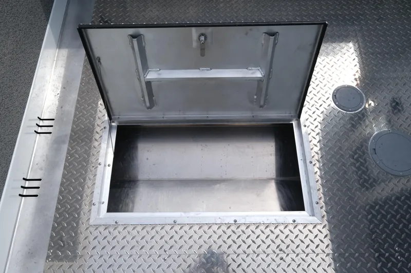 Slide: The Image of Open storage compartment on 2025 Hewescraft 240 Pacific Cruiser boat deck. - 19