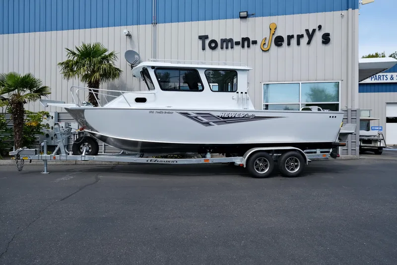 Slide: The Image of 2025 Hewescraft 240 Pacific Cruiser boat on trailer at dealership. - 2
