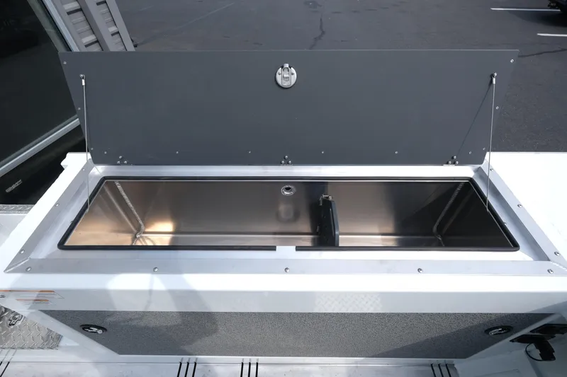 Slide: The Image of 2025 Hewescraft 240 Pacific Cruiser, open storage compartment on deck, stainless steel interior. - 20