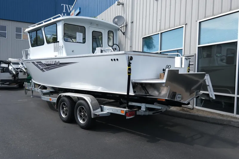 Slide: The Image of 2025 Hewescraft 240 Pacific Cruiser boat on trailer outside a building. - 4