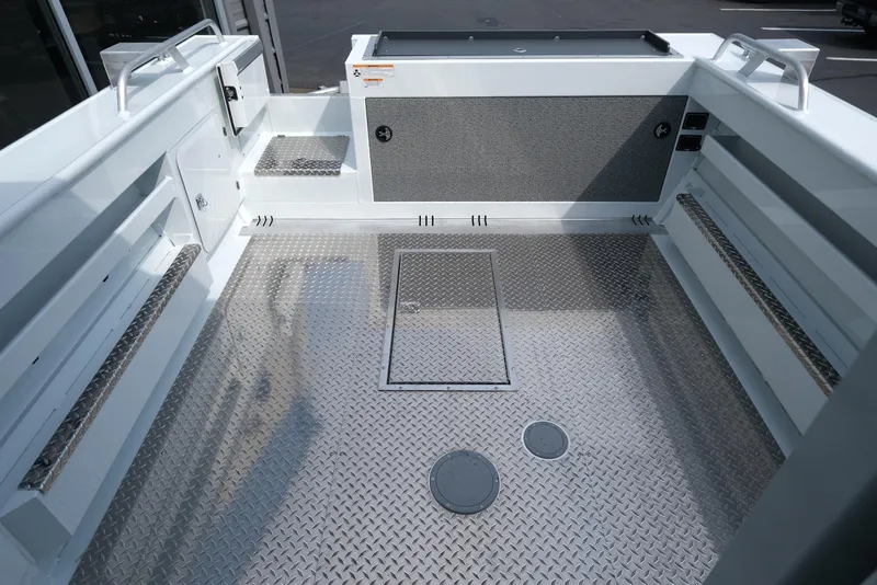 Slide: The Image of 2025 Hewescraft 240 Pacific Cruiser boat interior with diamond plate flooring. - 6