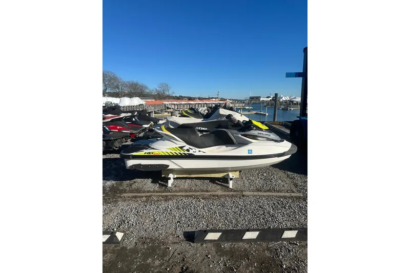 Slide: The Image of 2017 Sea-Doo RXT-X 300 jet ski parked near a marina on a sunny day. - 5