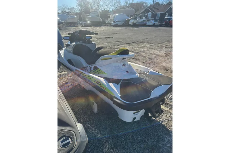 Slide: The Image of 2017 Sea-Doo RXT-X 300 jet ski parked on gravel lot. - 6