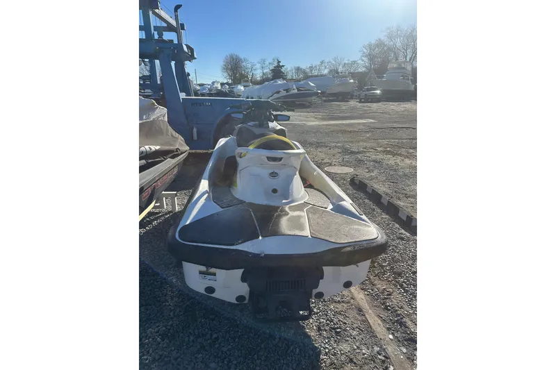 Slide: The Image of 2017 Sea-Doo RXT-X 300 jet ski parked on gravel lot under clear sky. - 8