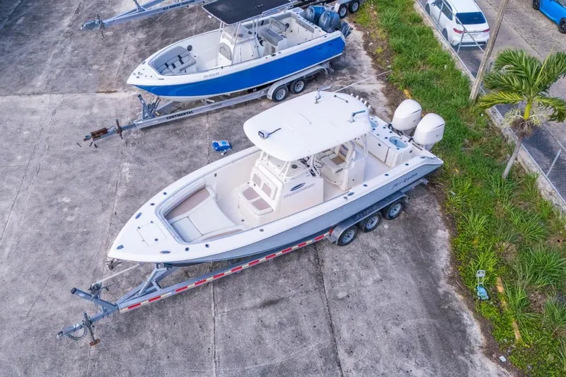 Slide: The Image of 2017 Cobia 296 Center Console boat on trailer, aerial view. - 12