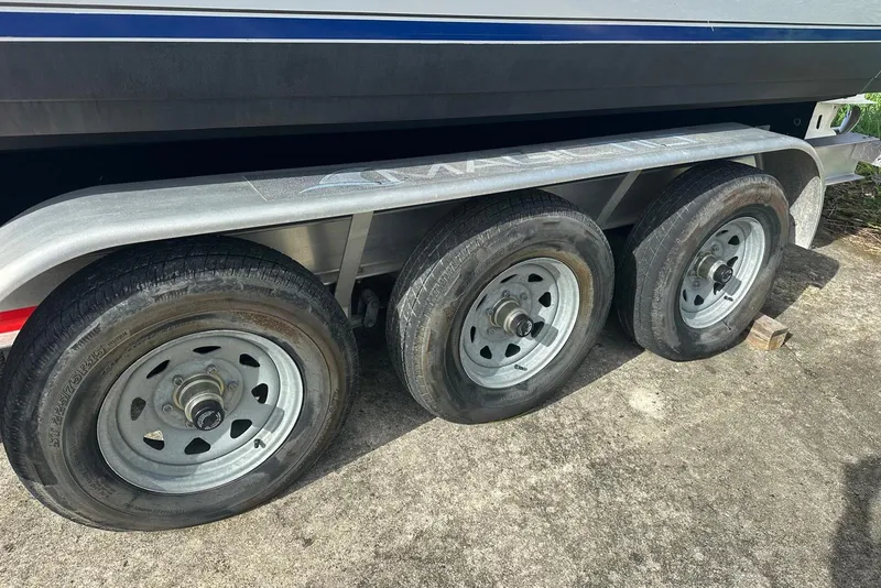 Slide: The Image of 2017 Cobia 296 Center Console boat on a triple-axle trailer. - 14