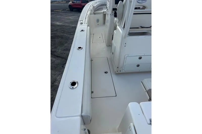 Slide: The Image of 2017 Cobia 296 Center Console boat interior with seating and storage compartments. - 26