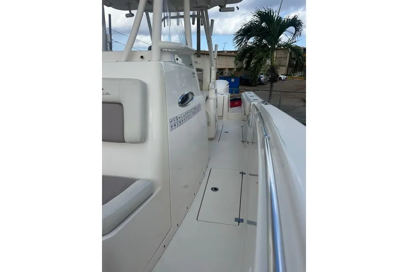 Slide: The Image of 2017 Cobia 296 Center Console boat, side view with seating and railings. - 28