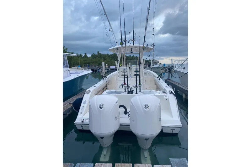 Slide: The Image of 2017 Cobia 296 Center Console boat docked with dual engines. - 3