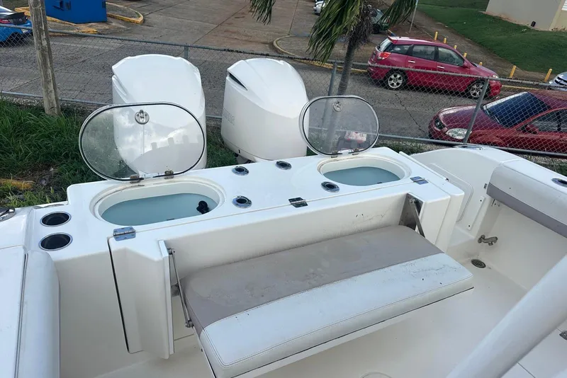 Slide: The Image of 2017 Cobia 296 Center Console boat with open storage compartments and seating. - 33